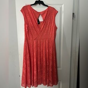 Peach knee length dress with floral stitching.